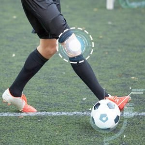 Footballer tackling on a pitch displaying knee injury